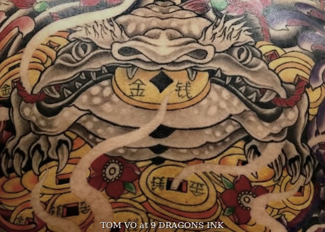 Money toad tattoo with coins by Tom Vo at 9 Dragons Ink in San Jose