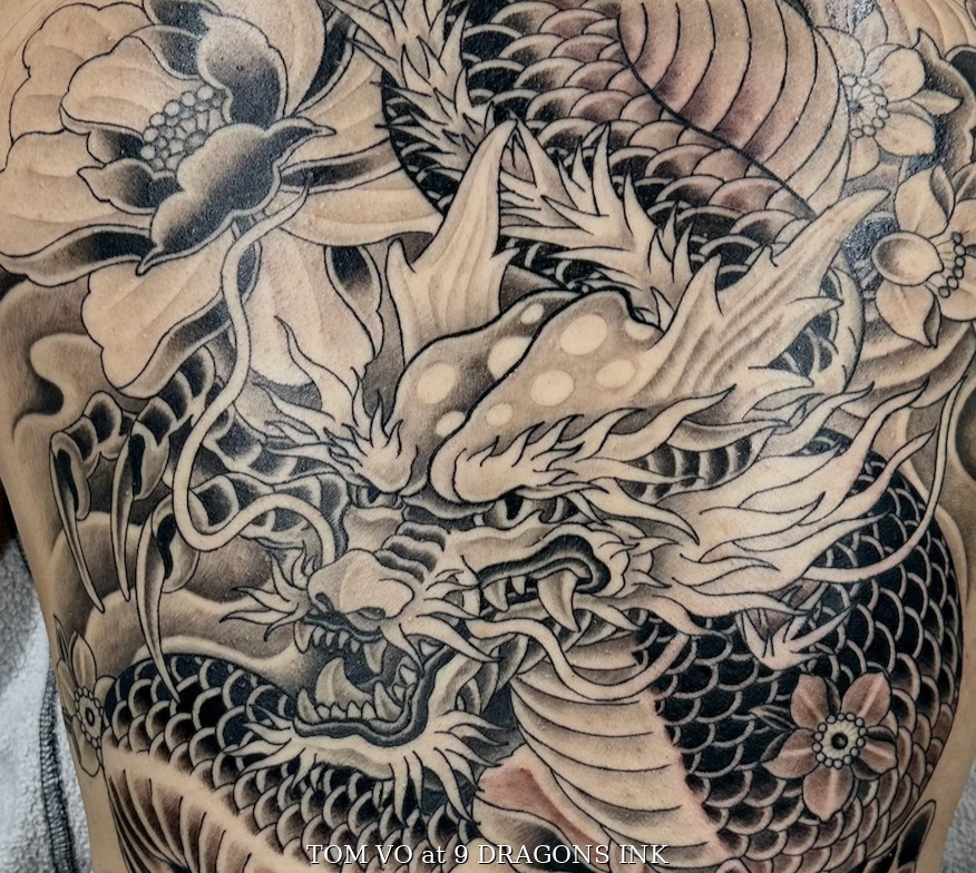 Dragon and floral tattoo detail by Tom Vo at 9 Dragons Ink in San Jose