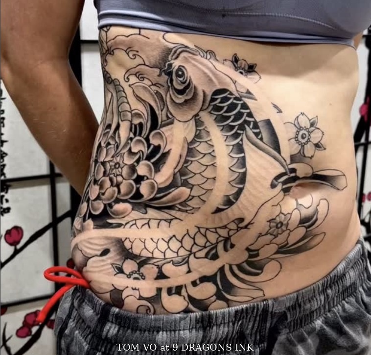 Koi and chrysanthemum waist tattoo by Tom Vo at 9 Dragons Ink in San Jose