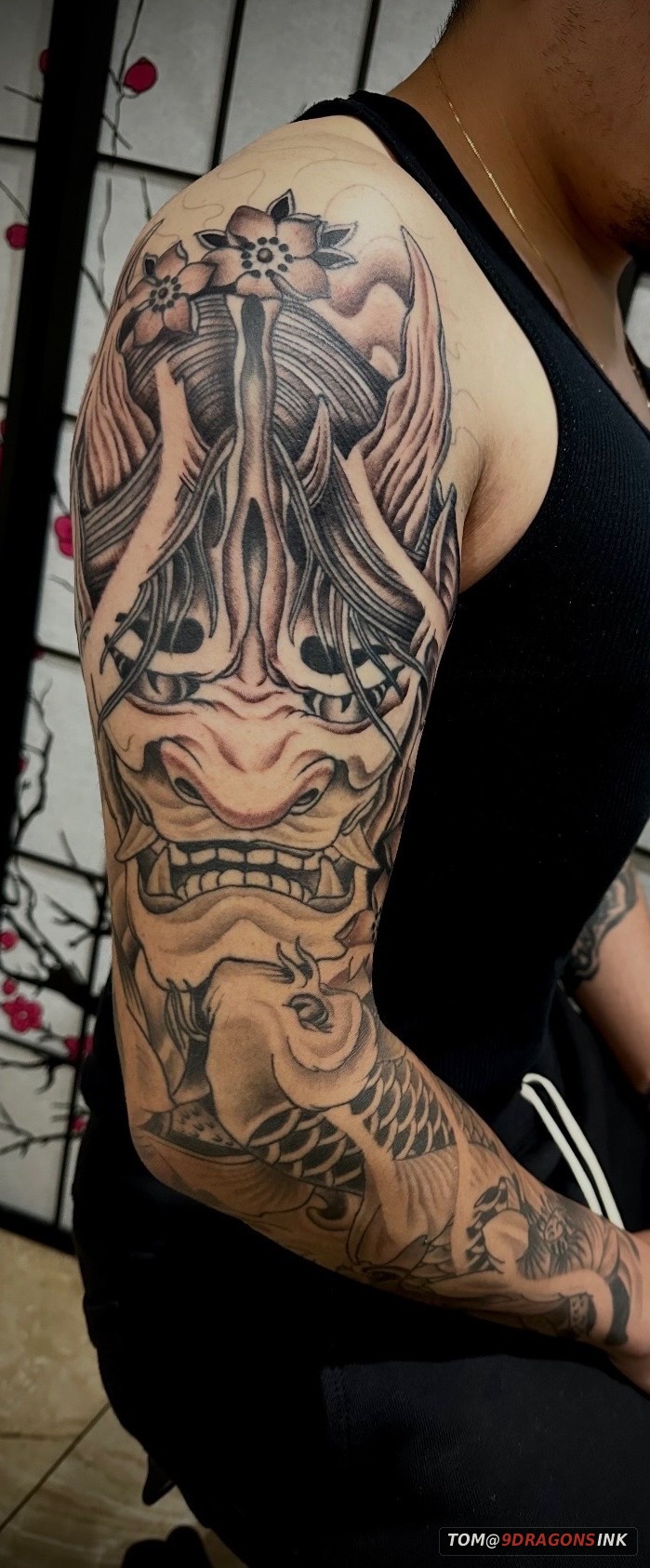 Japanese inspired sleeve tattoo with mask and koi by Tom at 9 Dragons Ink